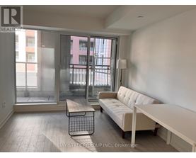 A living room with a white couch and a coffee table.