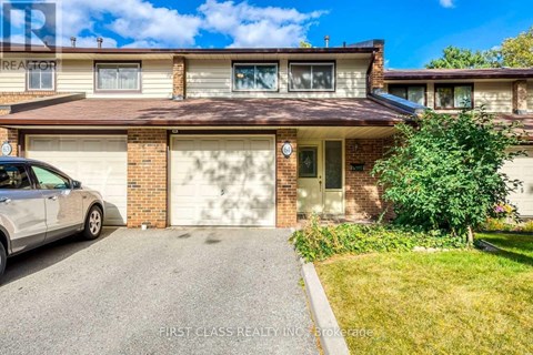 A house with a garage and a car parked in front.