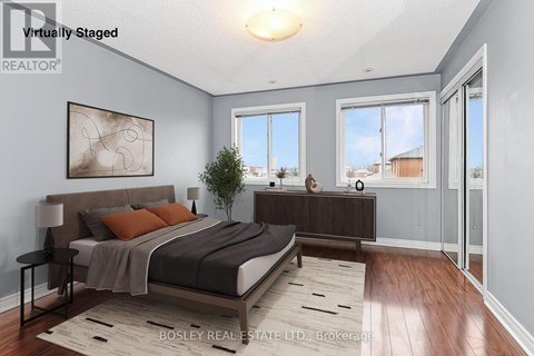 A bedroom with a large bed and a view of the city.