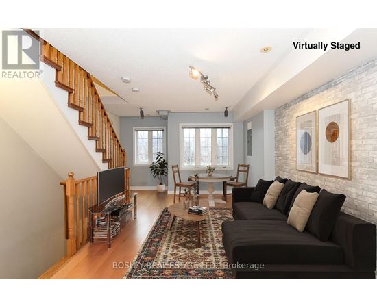 A living room with a couch, a chair, a coffee table, and a television.