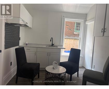 A small kitchen with a table and two chairs.