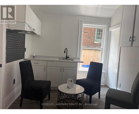 A small kitchen with a table and two chairs.