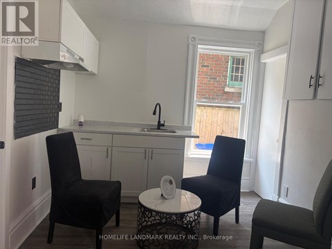 A small kitchen with a table and two chairs.