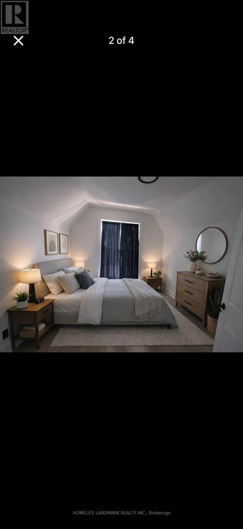A bedroom with a bed, nightstand, and lamp.
