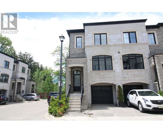 A large house with a car parked in front.