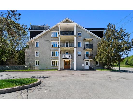 A large two-story building with a balcony on the second floor.