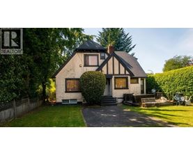 A house with a black and white facade is for sale.