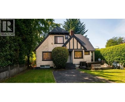 A house with a black and white facade is for sale.