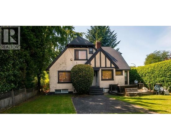 A house with a black and white facade is for sale.