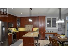 A kitchen with wooden cabinets and a granite countertop.