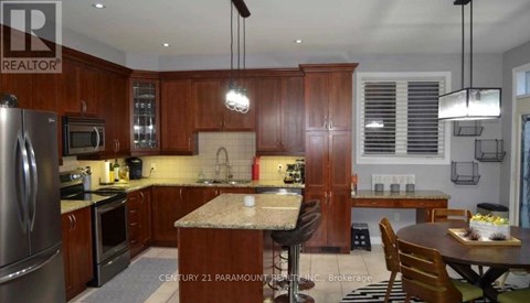 A kitchen with wooden cabinets and a granite countertop.