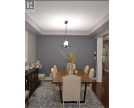 A dining room with a wooden table and chairs.