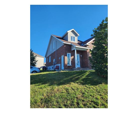 A house with a red brick exterior and white trim.