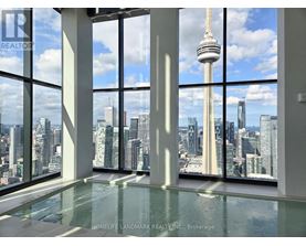 A room with a glass floor and a view of the cityscape.