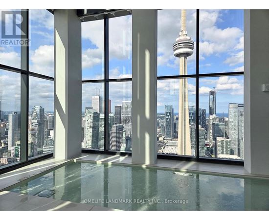 A room with a glass floor and a view of the cityscape.