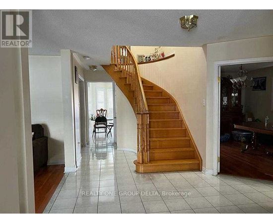A living room with a staircase leading to the upper floor.