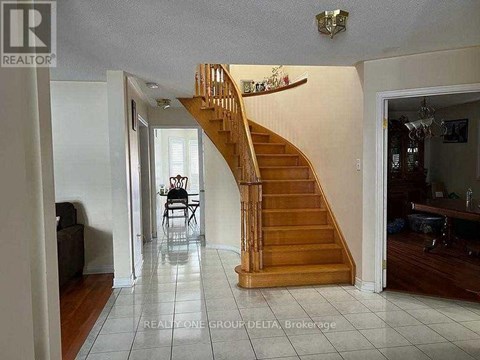 A living room with a staircase leading to the upper floor.