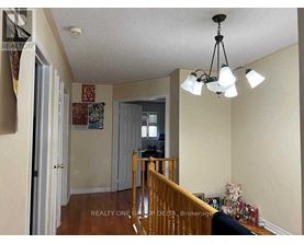 A living room with a staircase leading to the upper floor.