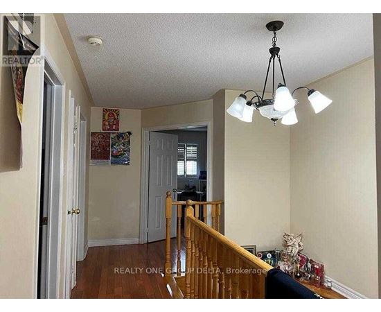 A living room with a staircase leading to the upper floor.