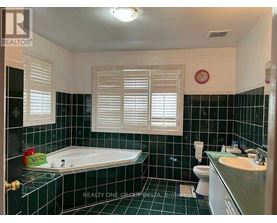 A bathroom with a black tiled floor and white walls.