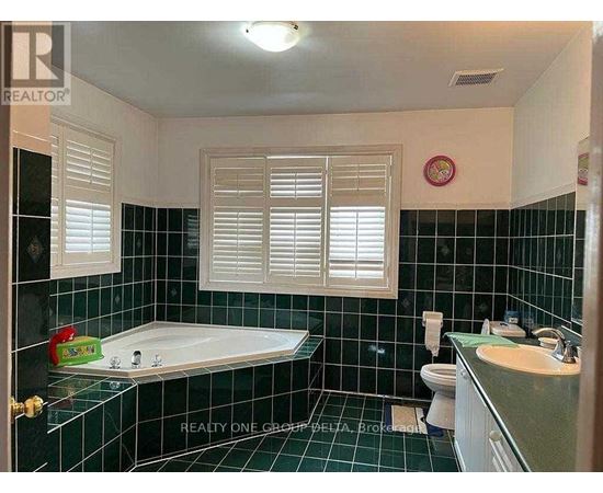 A bathroom with a black tiled floor and white walls.