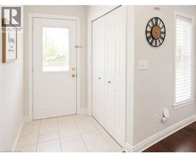 A white door with a clock on the wall.