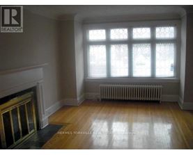 A room with a fireplace and a window.