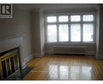 A room with a fireplace and a window.