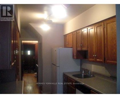 A kitchen with a sink and cabinets.