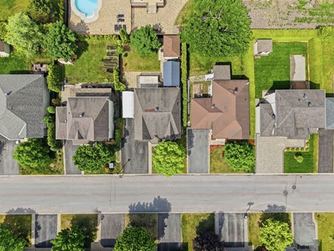 A suburban neighborhood with houses and a pool.