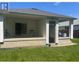 A small house with a porch and a bicycle on the left.