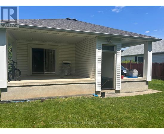 A small house with a porch and a bicycle on the left.