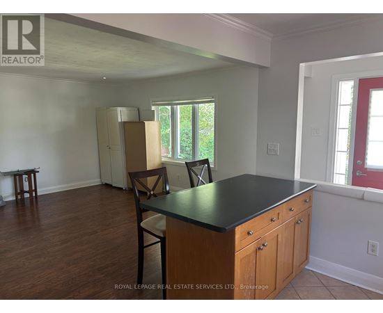 A kitchen with a black countertop and wooden cabinets.