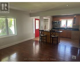 A kitchen with a bar stool and a counter.