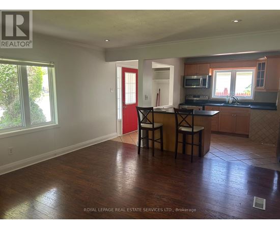 A kitchen with a bar stool and a counter.