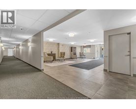 A spacious hallway with a carpeted floor and a door on the right.