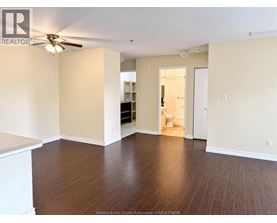 A room with a ceiling fan and wooden flooring.