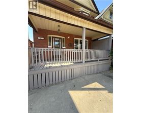 A house with a porch and a sign that says "REALTOR".