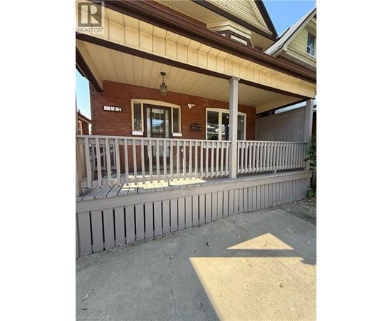 A house with a porch and a sign that says "REALTOR".