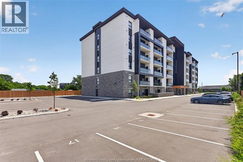 A parking lot in front of a building with a sign that says REALTOR.