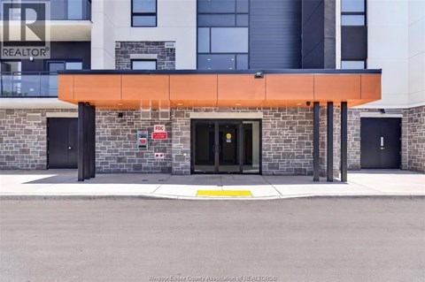 The front of a building with a black door and a sign that says REALTOR.