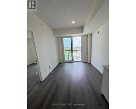 A spacious room with a view of the outside through a large window.