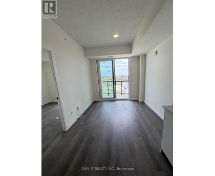 A spacious room with a view of the outside through a large window.