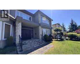 A house with a stone pillar in front of it.