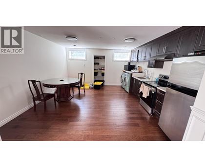 A kitchen with a table and chairs in it.