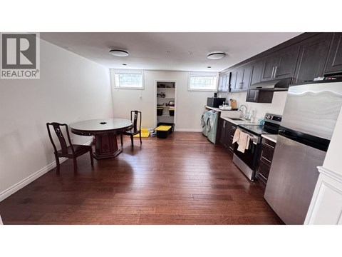 A kitchen with a table and chairs in it.