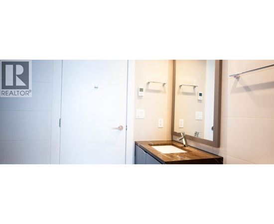 A bathroom with a sink and mirror.