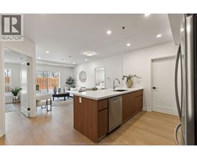 A modern kitchen with wooden cabinets and a large island.