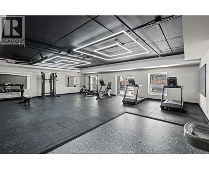 A gym with a variety of equipment including treadmills, weights, and exercise machines.