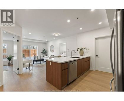 A modern kitchen with wooden cabinets and a large island.